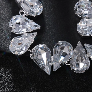 Luxe silver necklace with sparkling pear-cut crystal rhinestones on a black texture base