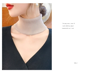 Detail view of a soft beige ribbed knit neck warmer for women's winter styling