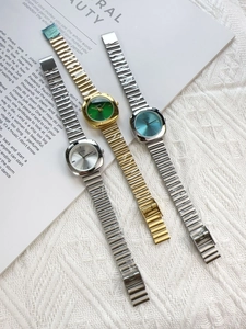 Three square steel quartz watches in gold-green, silver-blue, and silver-silver finishes