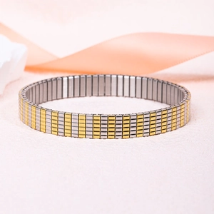 Detail of two-tone gold and silver stretch bracelet with brushed metal finish
