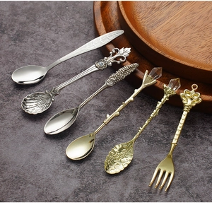 Detail view of 6-piece vintage metal spoons and forks set with crystal and floral handles