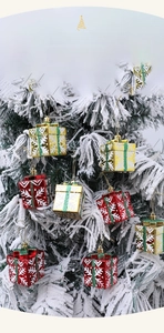 Detail of red and gold Christmas gift box ornaments with white snowflake patterns on a tree