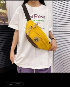 Detail of contrast color crossbody chest bag with hexagon logo and adjustable strap