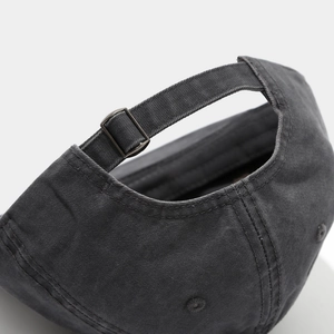 Close-up of adjustable metal buckle and twill cotton texture on vintage charcoal baseball cap