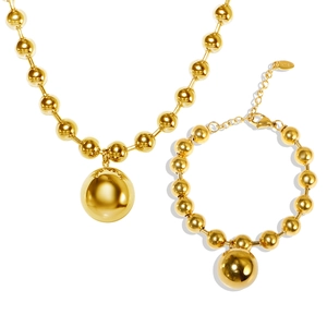Polished K18 gold hollow bead necklace and bracelet jewelry set on white background