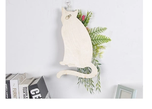 Detail of the back side of cat wooden wall decor showing the metal D-ring hook for hanging