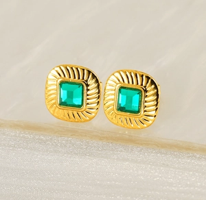 Detailed view of gold stainless steel square stud earrings with emerald green crystals