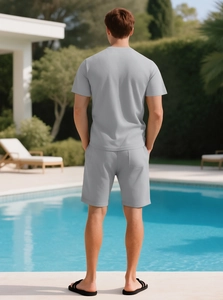 Men's light grey waffle knit shorts set shown from the back in a summer pool setting