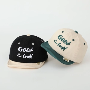 Close-up of Good Luck 3D embroidery on two-tone cotton baseball caps for kids