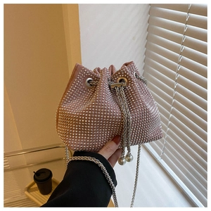 Pink rhinestone bucket bag detail showing silver chain strap and pearl fringe pendant