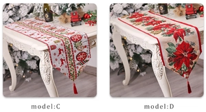 Detail of Christmas table runner with festive embroidery, elk patterns and red tassels