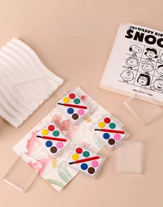 Detail of portable 6-color solid watercolor paint set with mini brush in clear case