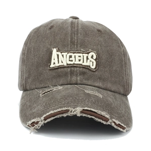 Detailed macro view of distressed dark grey baseball cap with 3D ANGELS embroidery