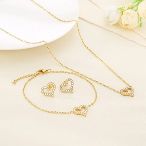 Golden heart jewelry set with necklace bracelet and earrings featuring micro-pave crystals