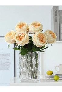 Detailed close-up of realistic champagne cream Austin roses in a textured glass vase