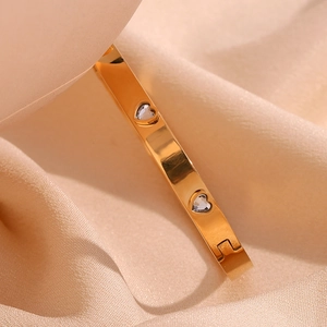 Detail of 18K gold-plated stainless steel bangle with micro-set heart zircons