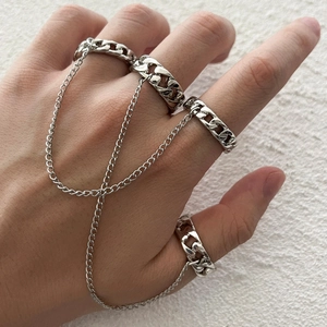 Silver punk style four-finger linked chain ring set for men and women on white background