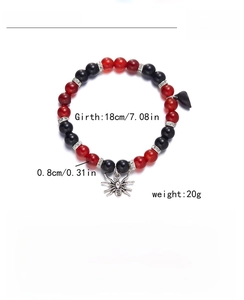 Detail of red agate and obsidian beads bracelet with spider charm and magnetic heart