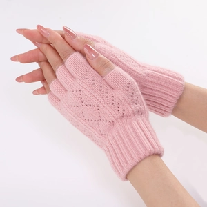 Detail of pink knitted fingerless gloves with diamond hollow pattern and soft wool texture
