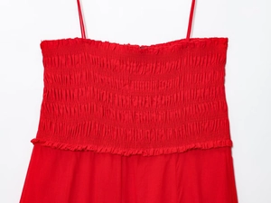 Close-up of red cotton midi dress featuring detailed smocking and elasticated bodice