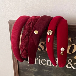 Detail of red vintage headbands in velvet and knit fabric with gold accents and pearls