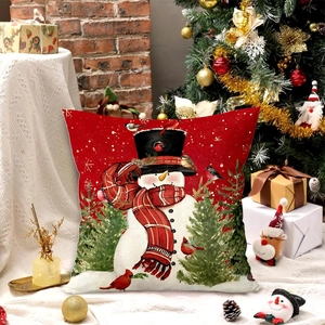 Close-up of red Christmas snowman pillowcase with festive holiday decor and warm lighting