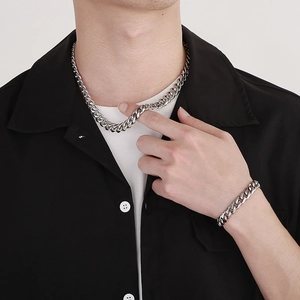 Polished silver stainless steel cuban chain necklace and bracelet set for men on model