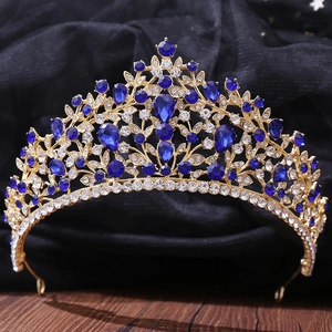 Detailed view of luxury gold bridal crown with blue teardrop crystals and fine diamonds