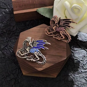 Vintage flying dragon brooches with inlaid rhinestones on hexagonal wooden base