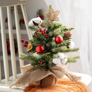 Mini Christmas tree desktop decor with red ornaments, pine cones, and burlap base