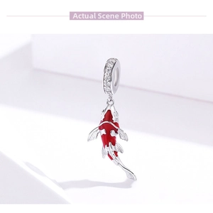 Macro shot of S925 sterling silver koi fish pendant with red glaze and zircon inlay
