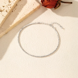Handcrafted S925 sterling silver faceted bead bracelet with delicate pendant on beige background