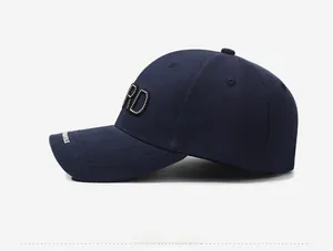 Detail view of navy blue baseball cap with 3D embroidery and side printed logo