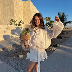 White chiffon mini dress with V-neck and ruched waist for a stylish summer vacation look