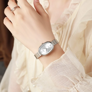 Women's quartz watch with silver oval case and bamboo steel band worn on a female wrist
