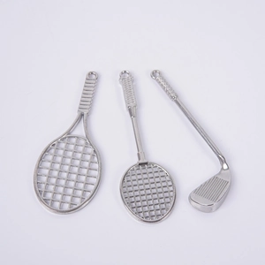 Miniature silver metal tennis, badminton and golf club keychains shown on white background