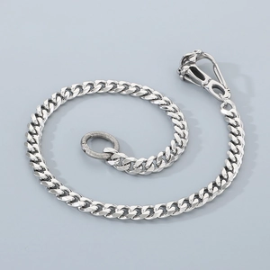 Close-up of polished silver stainless steel Cuban link chain with lobster clasp and metal ring