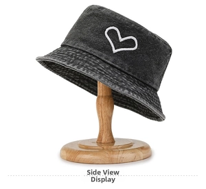 Detailed view of grey washed denim bucket hat with white heart embroidery stitching