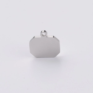Macro shot of an octagonal blank silver pendant made of polished stainless steel metal