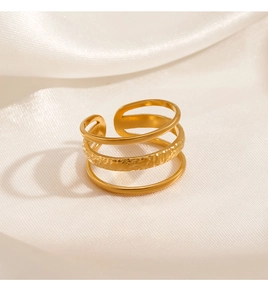 Close-up of 18K gold plated adjustable ring with triple layered texture on white silk
