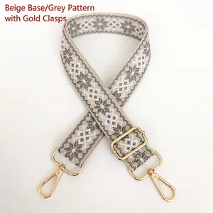 Macro view of 3.8cm canvas bag strap with grey diamond jacquard and gold metal hooks