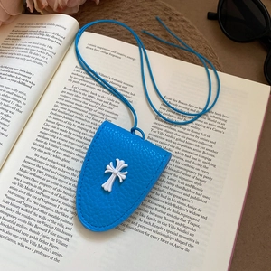 Detail of blue cross leather glasses holder necklace showing lychee grain texture