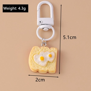 Creative toast bread keychain with heart fried eggs detail and dimensions of 5.1cm by 2cm