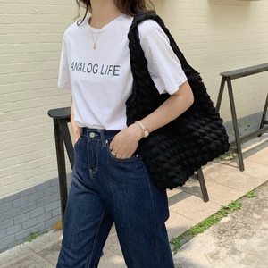 Close-up of black puffy cloud texture shoulder bag with large capacity in street style
