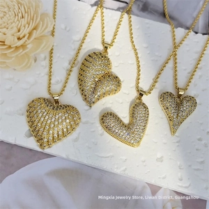 Detailed view of four 18K gold plated heart necklaces with micro-set cubic zirconia stones
