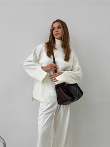 White turtleneck knit sweater with cuff slit design and matching white trousers outfit