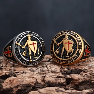Detailed close-up of shield signet rings with embossed knight and bible verse engraving