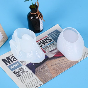 Close-up of translucent swan storage box silicone mold on vintage newspaper background