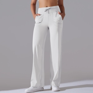 Detailed macro view of the drawstring high waist and side pocket on white wide-leg yoga pants