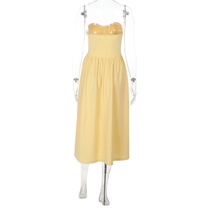 Detailed view of the yellow strapless pleated dress with slim waist design and light fabric